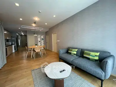 Spacious modern living room with stylish furniture and open kitchen layout