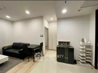 Modern living room with sleek black sofa and dining table, perfect for urban living.
