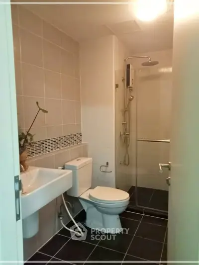 Modern bathroom with sleek fixtures and glass shower enclosure