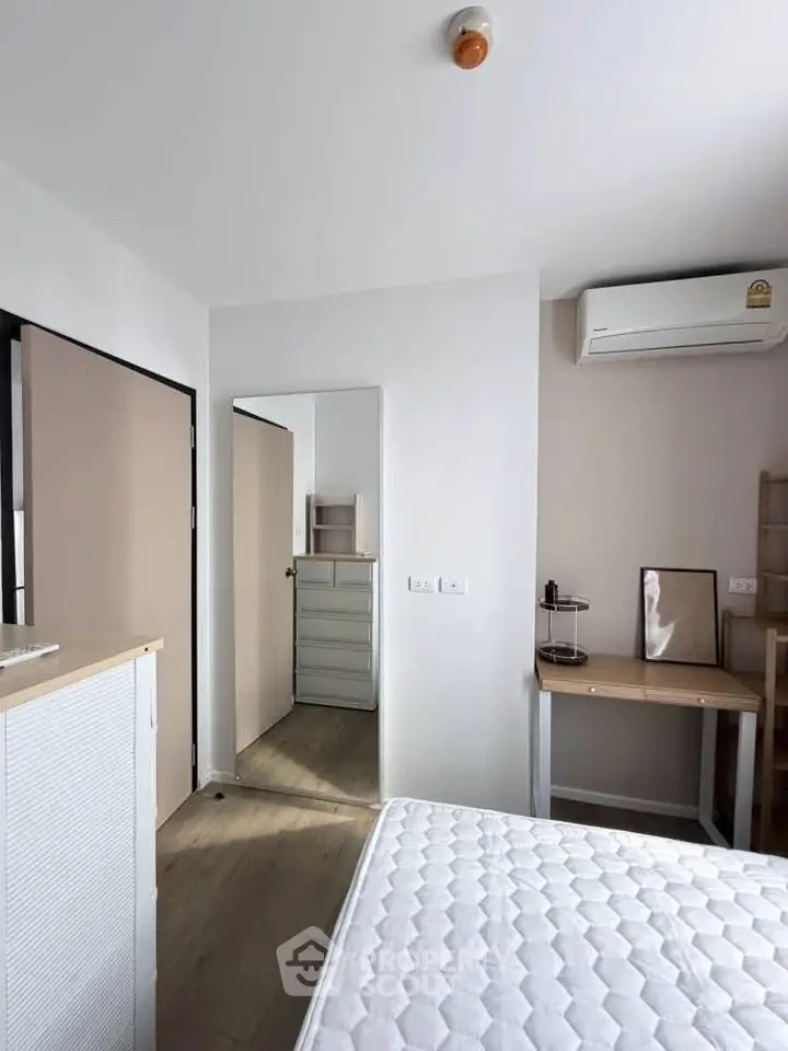 Modern bedroom with minimalist decor and air conditioning unit