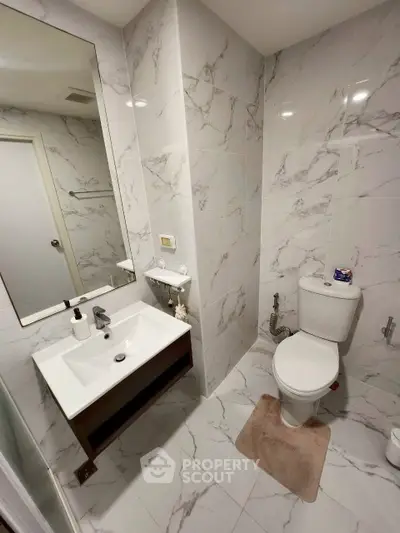 Modern bathroom with marble tiles and sleek fixtures