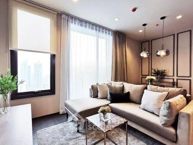 Modern living room with stylish decor and city view, featuring a cozy sectional sofa and elegant lighting.