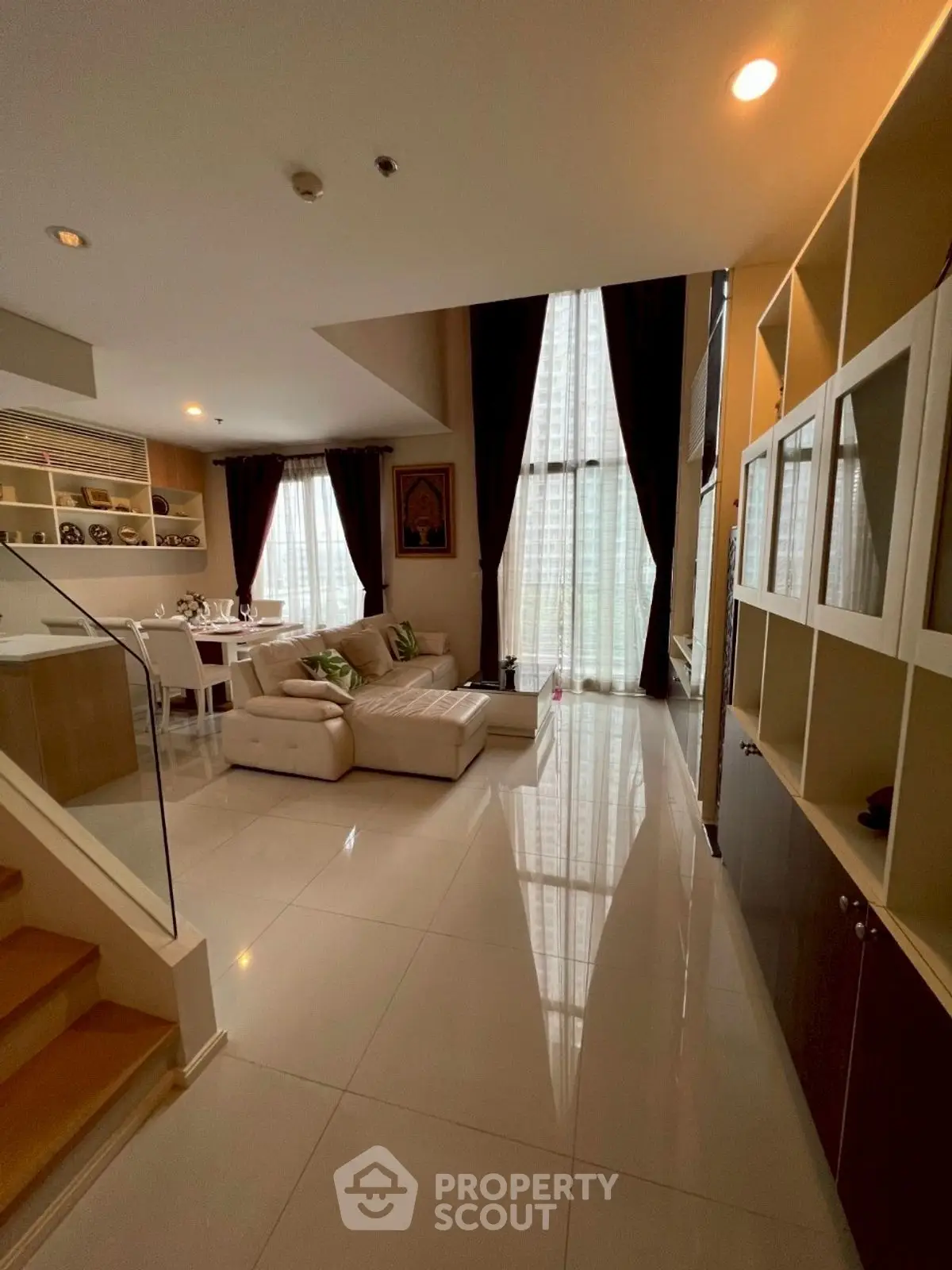 Luxurious modern living room with high ceilings and elegant decor in a spacious apartment