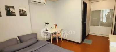 Cozy bedroom with modern decor, featuring a comfortable bed, study desk, and ample closet space.