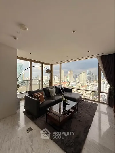 Luxurious corner unit living room with panoramic city views and elegant furnishings.