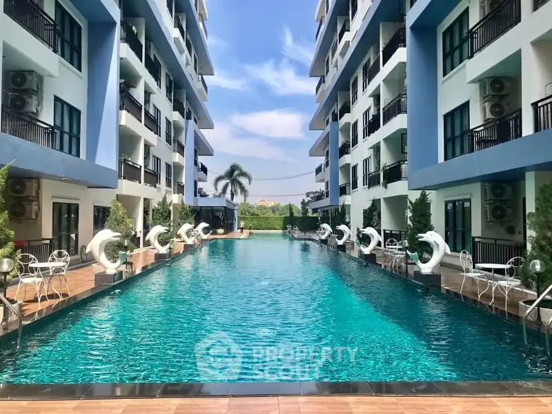 Luxurious apartment complex with stunning outdoor pool and modern architecture.