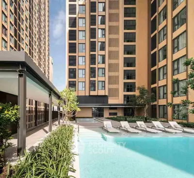 Luxurious apartment complex with a stunning outdoor pool and modern architecture.