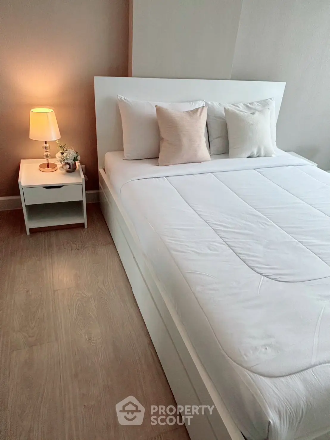 Cozy bedroom with modern white bed and soft lighting