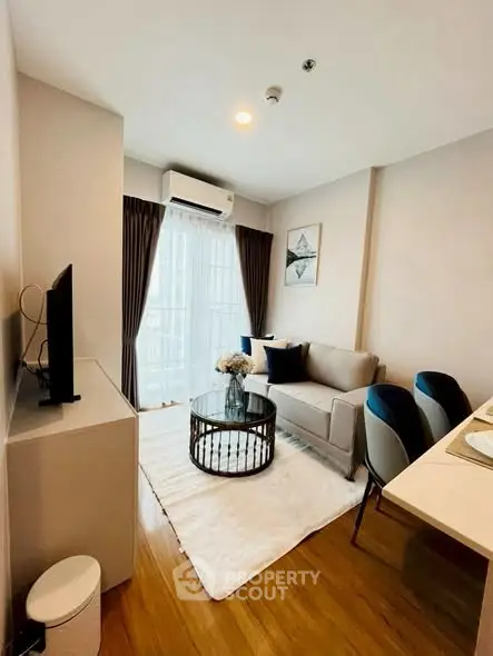 Modern living room with cozy sofa, stylish decor, and natural light.