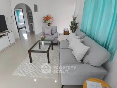 Spacious living room with modern gray furniture and elegant decor, perfect for relaxation and entertaining.