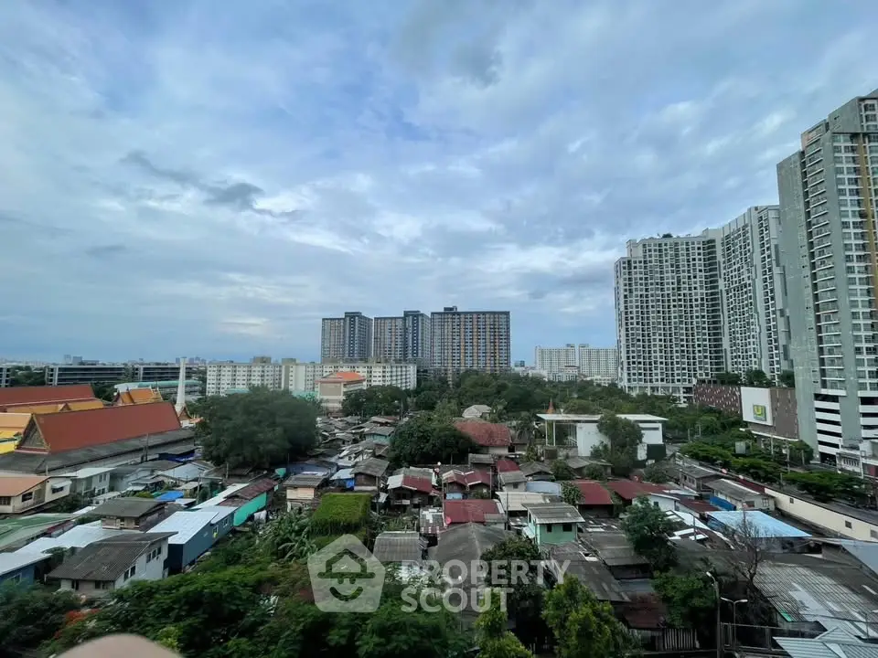 Stunning cityscape view showcasing high-rise buildings and residential area under a vibrant sky.