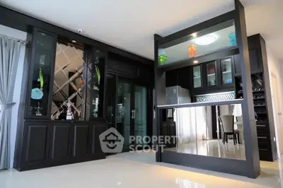 Elegant modern living room with built-in cabinets and open kitchen layout, perfect for stylish entertaining.