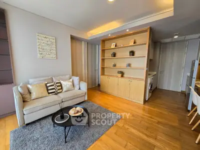 Modern living room with cozy sofa, stylish decor, and wooden flooring in a contemporary apartment.