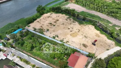 Prime riverfront land for sale with lush greenery and development potential.