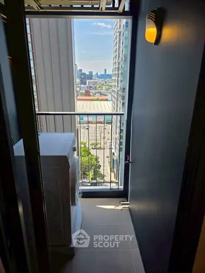 Compact balcony with washing machine and city view in modern apartment