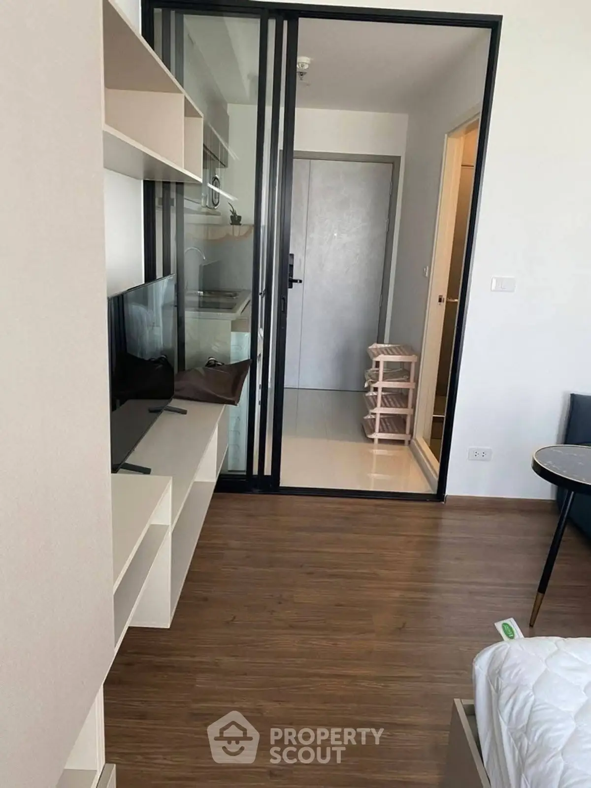 Modern apartment interior with sliding glass doors and wooden flooring