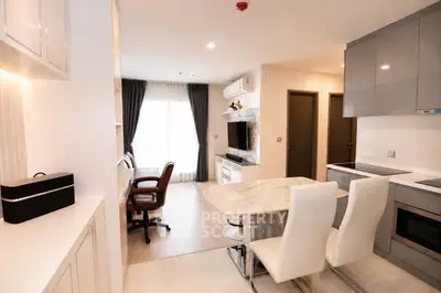 Modern open-plan kitchen and living area with sleek design and natural light.