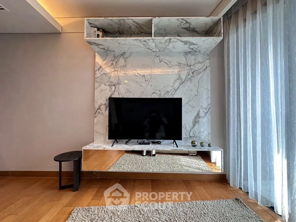 Modern living room with marble TV wall and stylish decor