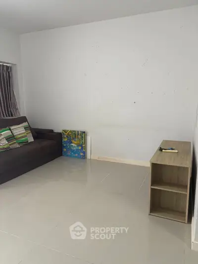 Minimalist living room with tiled floor and modern furniture, perfect for cozy gatherings.