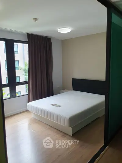 Modern bedroom with large window and minimalist decor