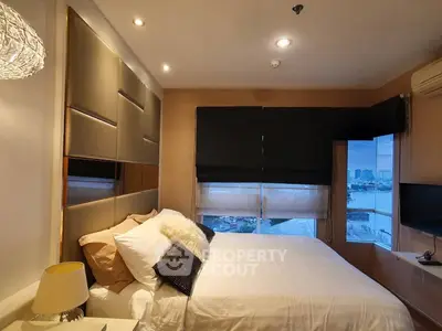 Luxurious bedroom with city view, modern decor, and ambient lighting
