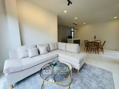 Spacious modern living room with cozy sectional sofa and elegant dining area
