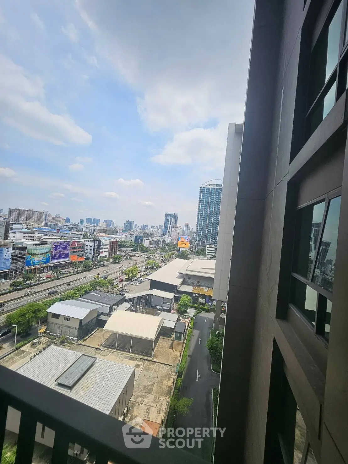 Stunning urban view from high-rise balcony overlooking cityscape and skyline.