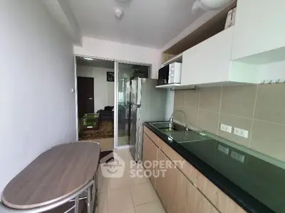 Modern kitchen with sleek cabinets and stainless steel appliances in a compact layout.