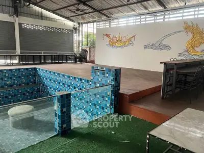 Unique indoor space with tiled pool and artistic wall mural, ideal for creative events.
