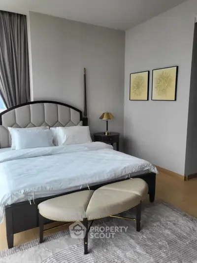 Luxurious bedroom with elegant decor and plush bedding in a modern apartment.