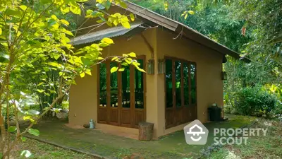 Charming rustic cabin surrounded by lush greenery, perfect for nature lovers seeking tranquility.