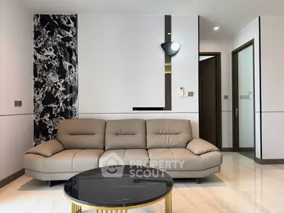 Modern living room with elegant marble accents and stylish beige sofa