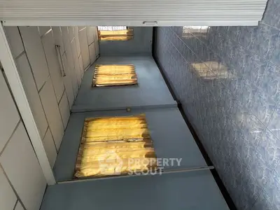 Spacious room with tiled walls and large windows, ideal for customization.
