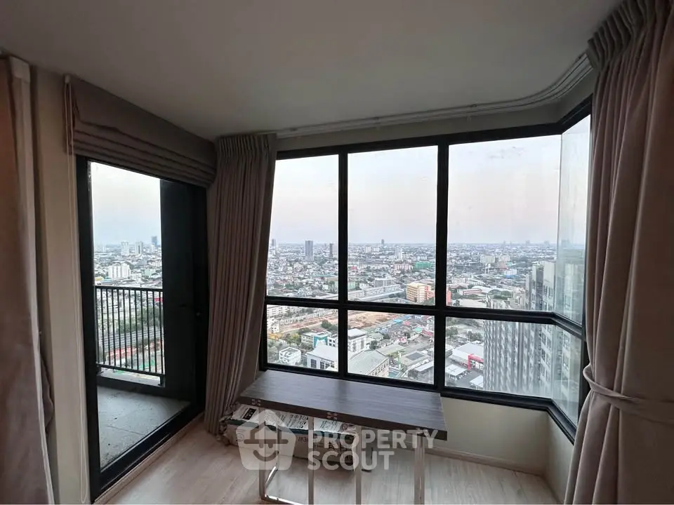 Stunning high-rise apartment with panoramic city views and floor-to-ceiling windows.