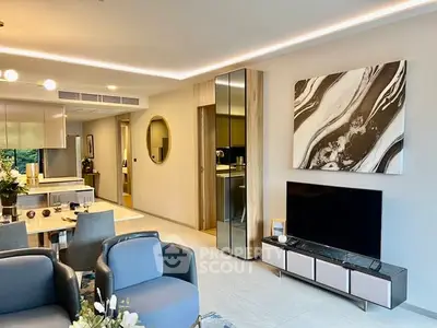 Modern living room with stylish decor and open dining area, featuring elegant furniture and contemporary art.