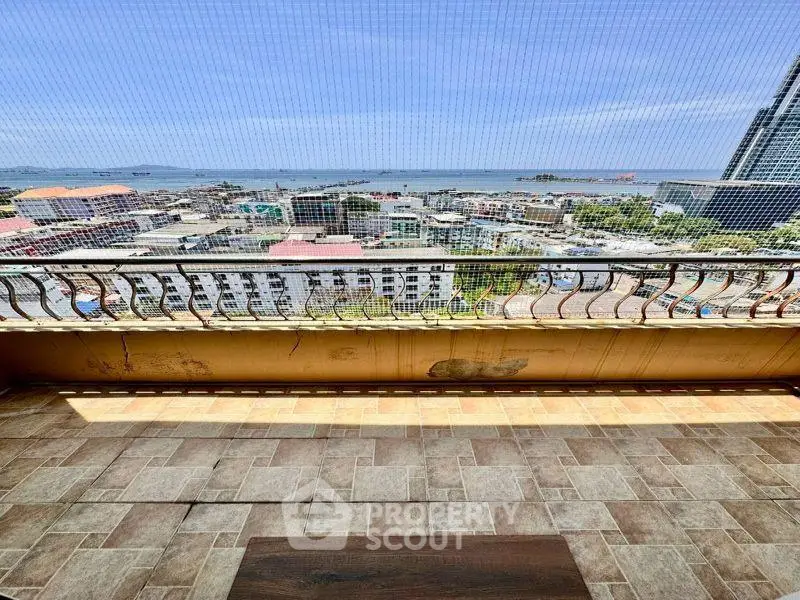 Stunning balcony view overlooking cityscape and ocean, perfect for relaxation and enjoying sunsets.
