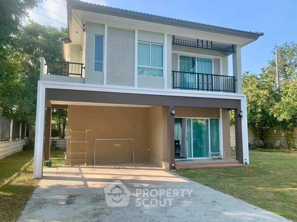 Modern two-story house with spacious driveway and lush garden