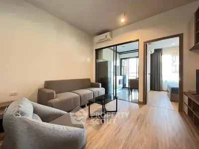 Modern living room with stylish furniture and wooden flooring in a contemporary apartment.