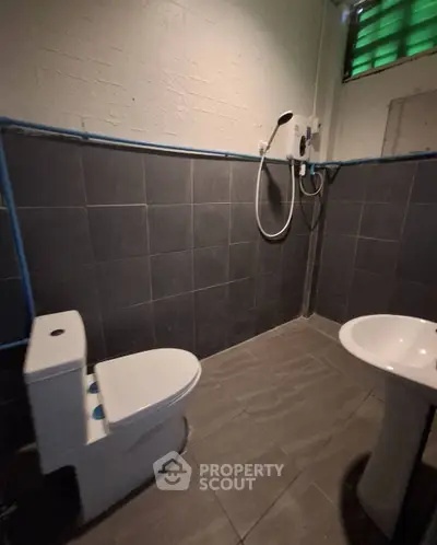 Modern bathroom with sleek gray tiles and contemporary fixtures