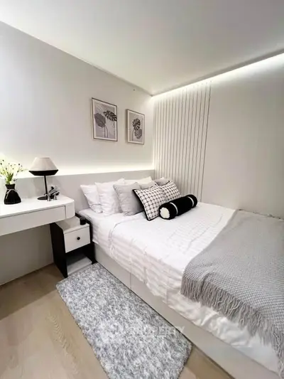 Modern minimalist bedroom with cozy decor and stylish lighting