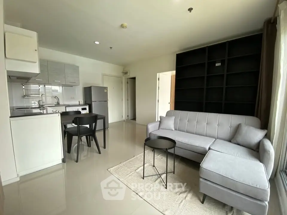 Modern living room with sleek furniture and open kitchen layout