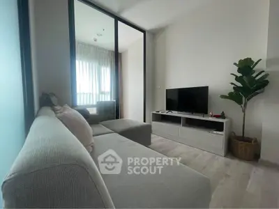 Modern living room with sleek furniture and natural light, perfect for relaxation and entertainment.