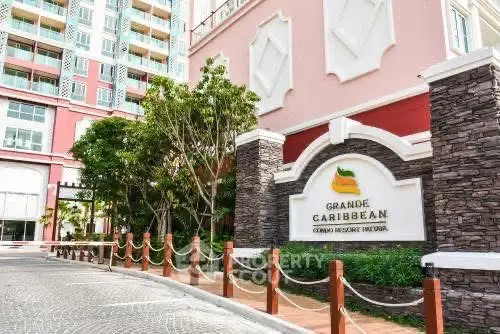 Grande Caribbean condo entrance with elegant signage and lush landscaping.