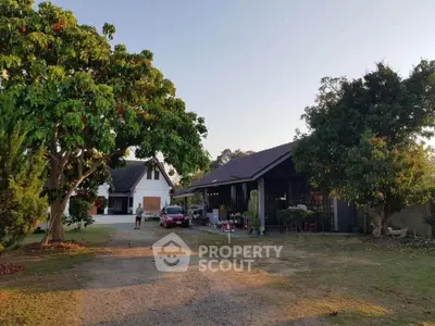 Charming countryside property with spacious yard and lush greenery, perfect for serene living.