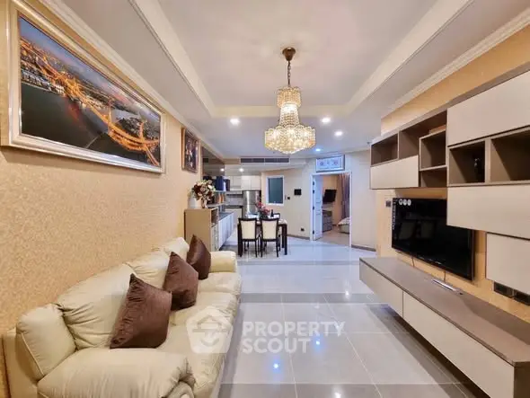 Luxurious living room with elegant chandelier and modern entertainment unit