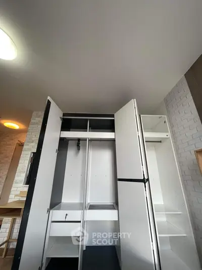 Spacious modern wardrobe with open doors in a stylish interior setting.