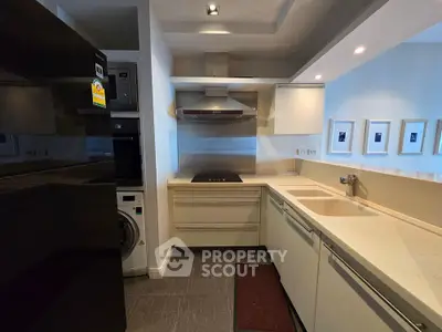 Modern kitchen with sleek cabinetry and built-in appliances in a stylish apartment.