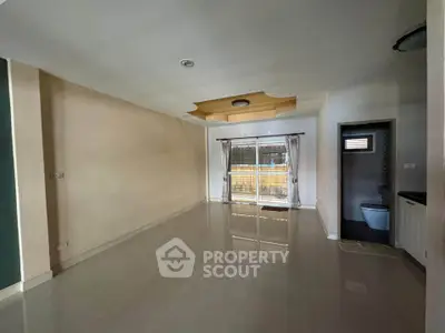 Spacious empty living room with large windows and modern ceiling design