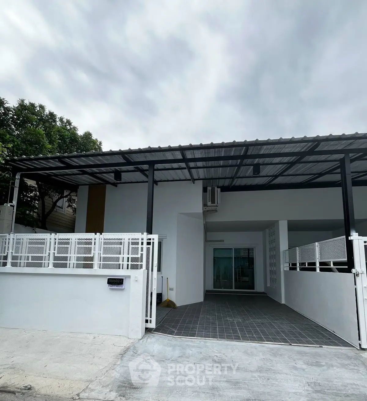 Modern single-story house with covered carport and sleek exterior design.