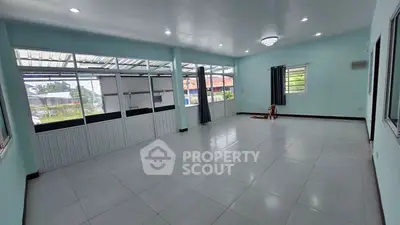 Spacious empty room with large windows and tiled floor, ideal for customization.